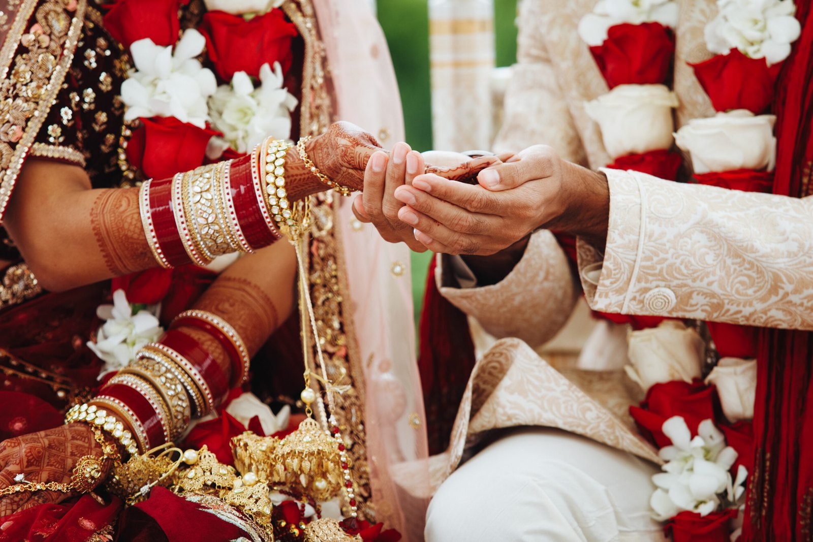 Epic Knots 24 Hands of indian bride and groom intertwined together making authentic wedding ritual